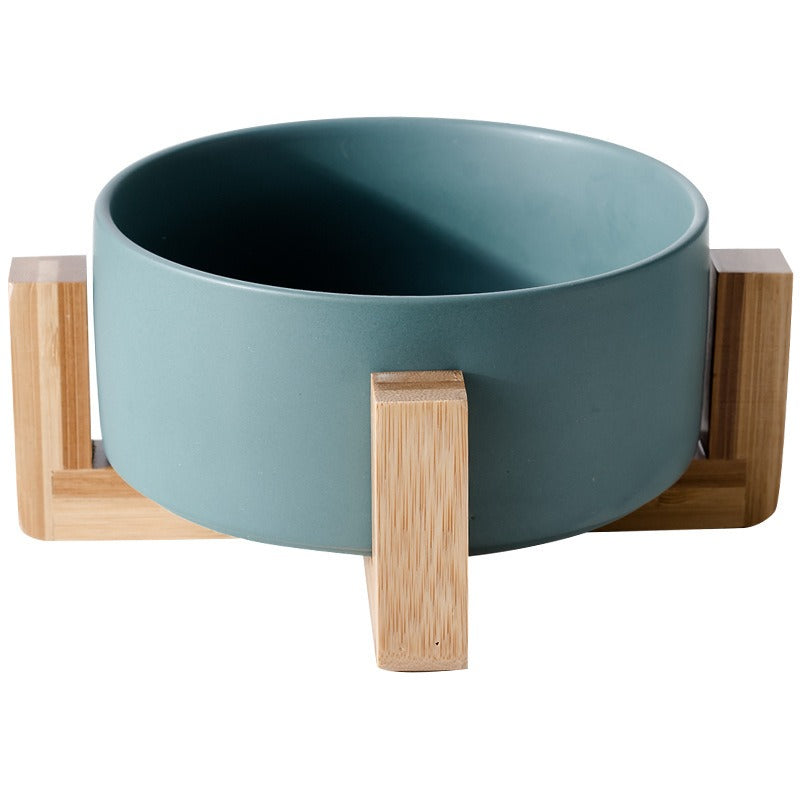 Ceramic food bowl with stable wooden base in a clean design