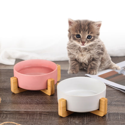 Ceramic food bowl with stable wooden base in a clean design