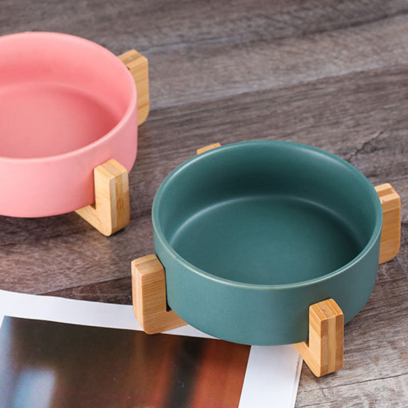 Ceramic food bowl with stable wooden base in a clean design