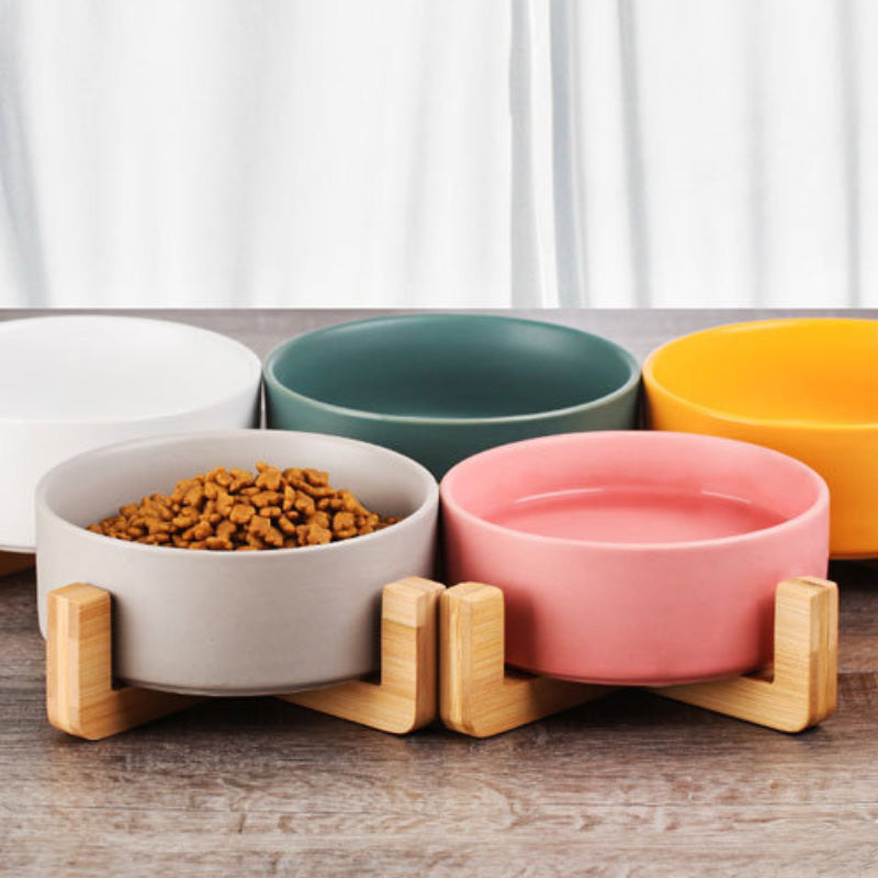Ceramic food bowl with stable wooden base in a clean design